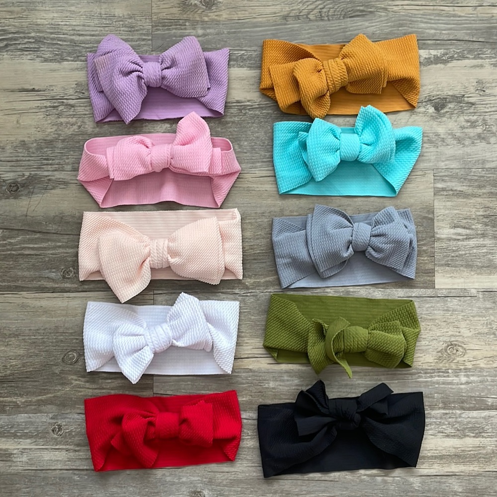 29 headband bows of various styles and colors for 0-2T fit depending on style.